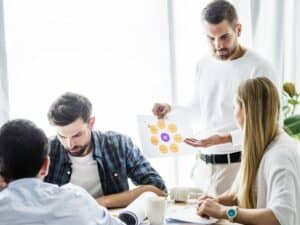businessman-showing-chart-his-female-employee-workplace-min