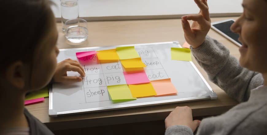 high-angle-woman-girl-playing-memory-game-min